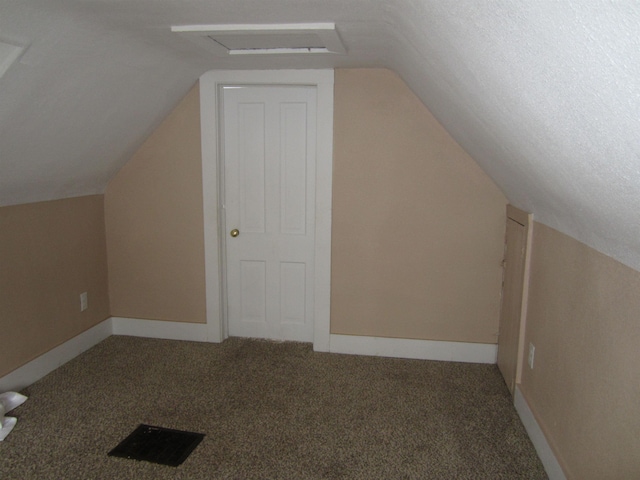 bonus room featuring lofted ceiling and carpet flooring