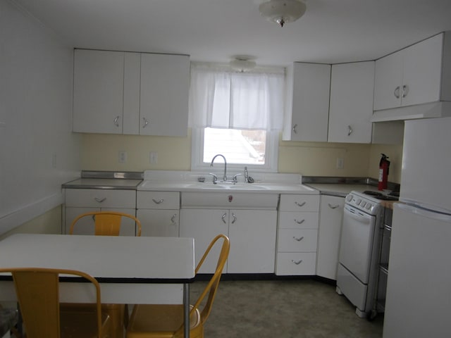 kitchen featuring sink, white cabinets, and white appliances