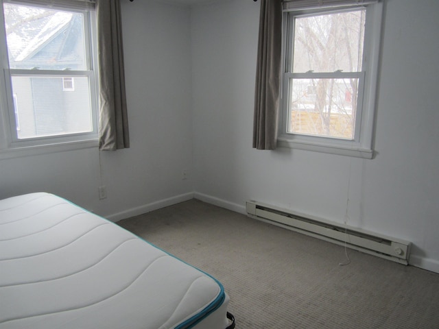 carpeted bedroom featuring baseboard heating