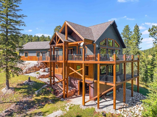 exterior space with a wooden deck and central air condition unit