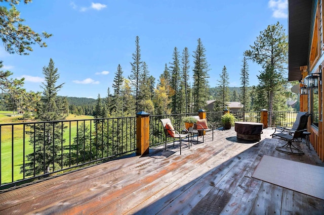 wooden terrace featuring an outdoor fire pit