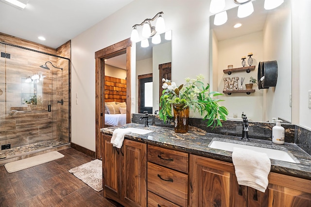 bathroom with a shower with door and vanity