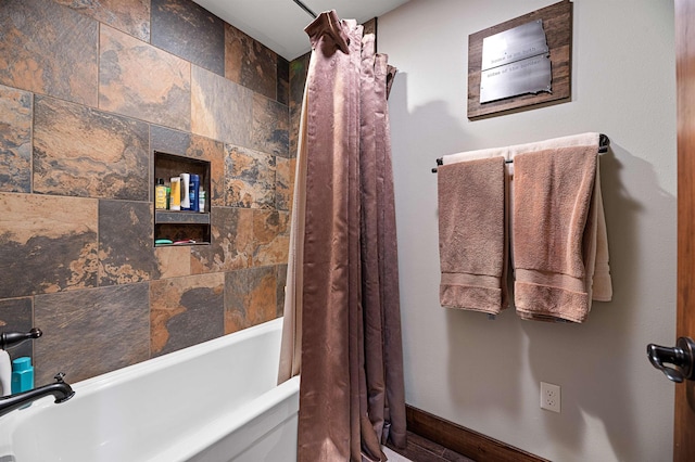 bathroom with shower / bath combo with shower curtain