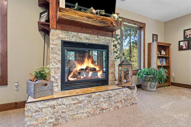 interior details with a stone fireplace and carpet flooring