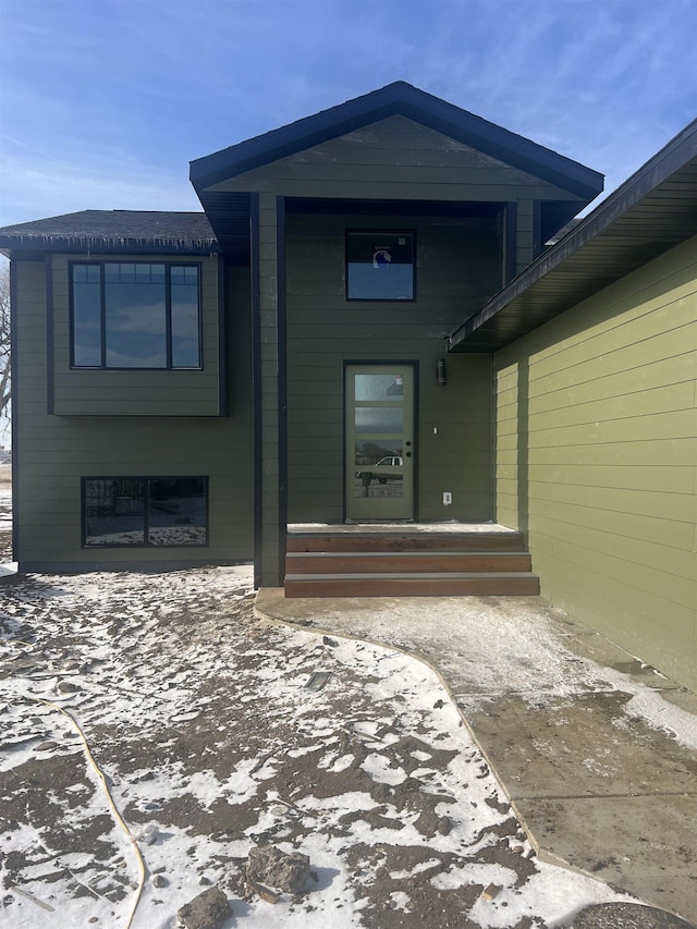 view of exterior entry featuring a patio area