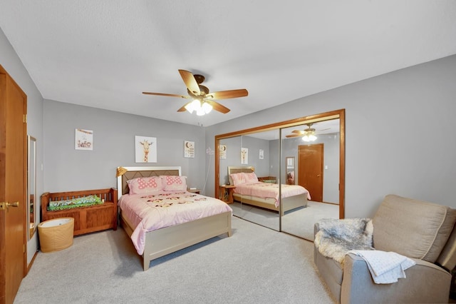 carpeted bedroom with a closet and ceiling fan