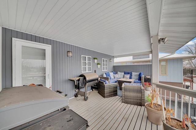 wooden deck featuring area for grilling and an outdoor hangout area