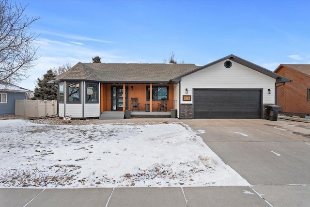 single story home with a garage and covered porch