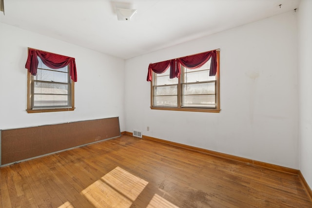 empty room with hardwood / wood-style flooring