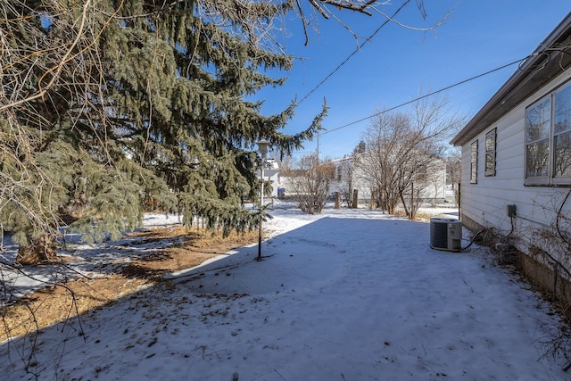 yard covered in snow featuring cooling unit