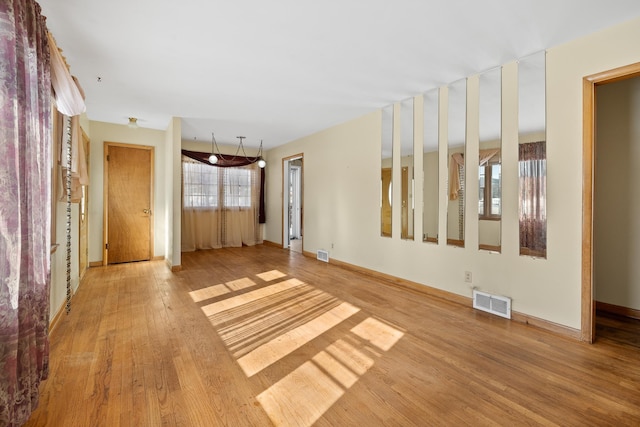 unfurnished living room with hardwood / wood-style floors