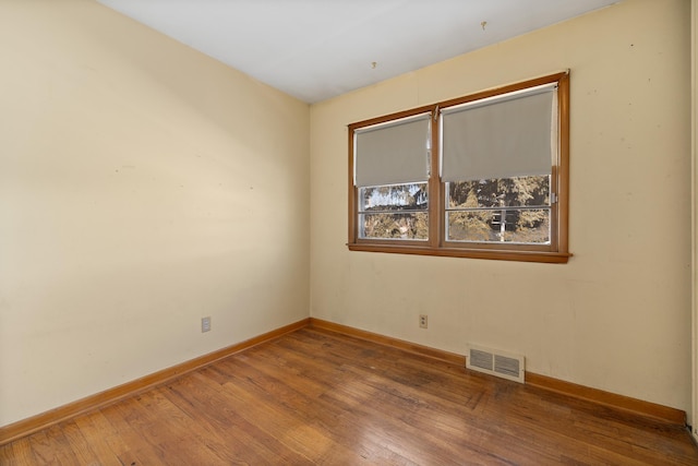 unfurnished room featuring hardwood / wood-style flooring