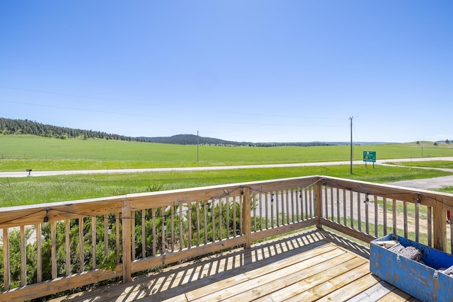 wooden deck featuring a rural view