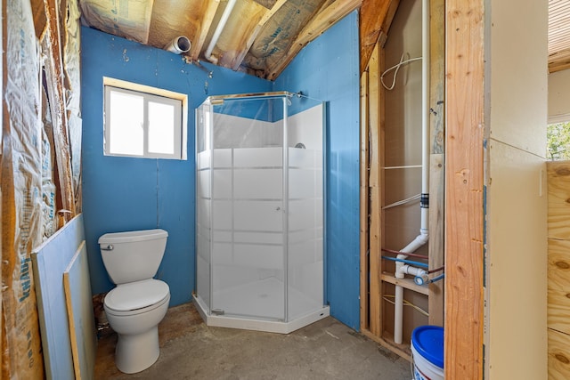 bathroom featuring toilet, concrete flooring, and an enclosed shower