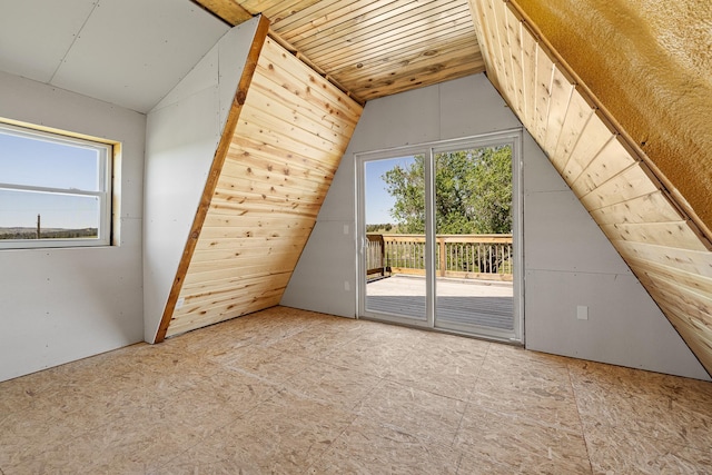 bonus room featuring lofted ceiling, wooden ceiling, and a healthy amount of sunlight