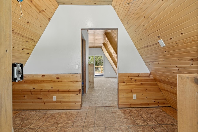 additional living space with wood ceiling, wooden walls, and vaulted ceiling