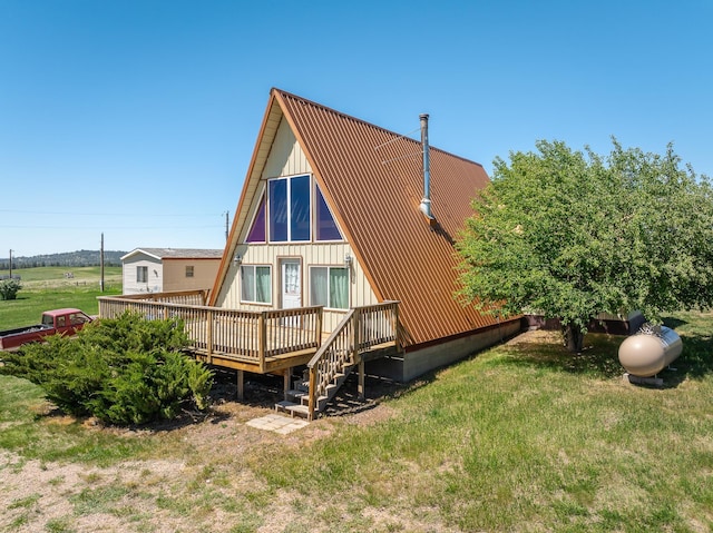 back of property featuring a yard and a deck