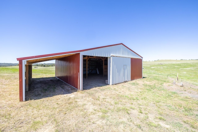 view of stable featuring a rural view