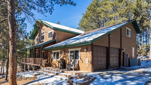 rear view of property featuring a garage