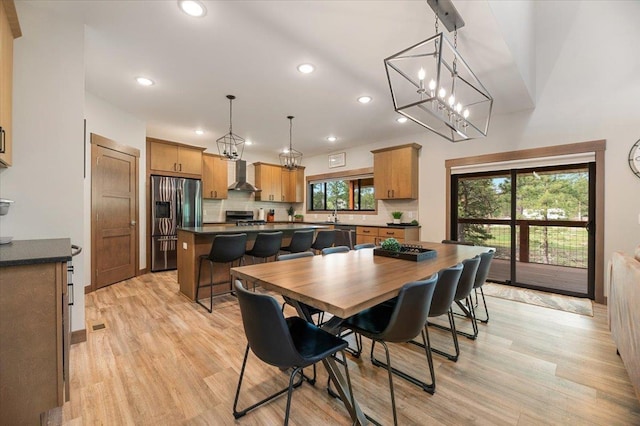 dining area featuring light wood-type flooring and sink