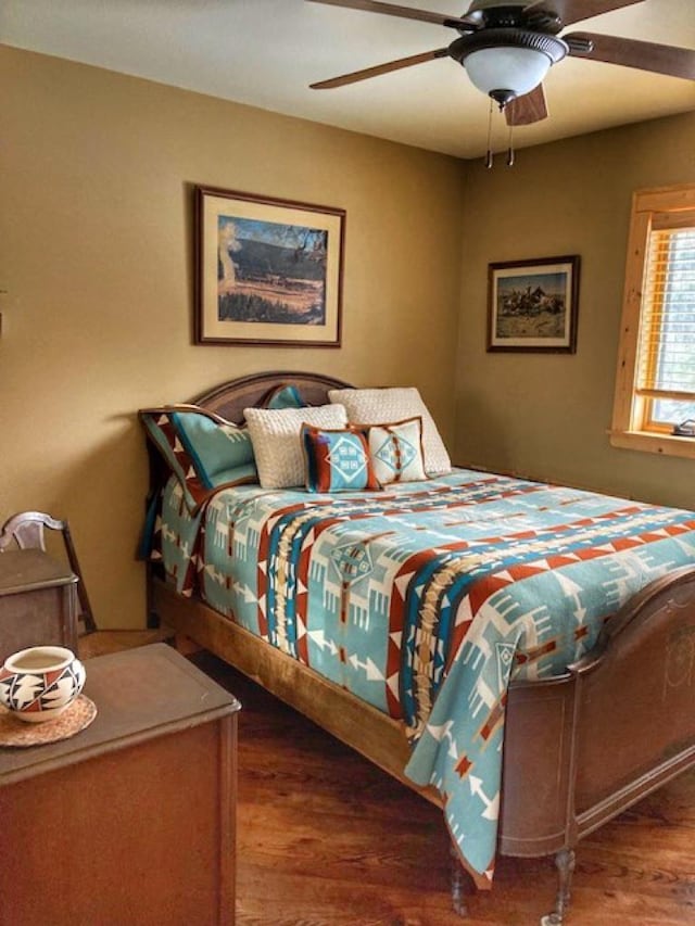 bedroom with ceiling fan and wood finished floors