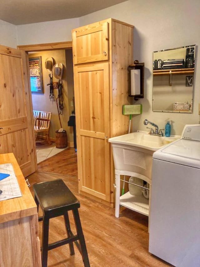 washroom featuring laundry area, washer / clothes dryer, and light wood-style floors