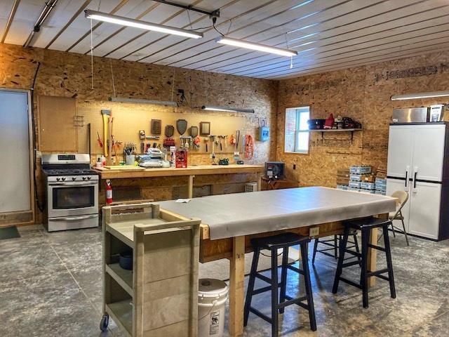 kitchen with open shelves and stainless steel gas range