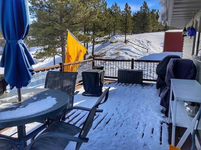 snow covered deck with grilling area