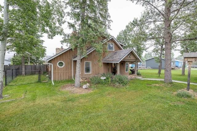 view of front of property featuring a chimney, fence, a front lawn, and roof with shingles