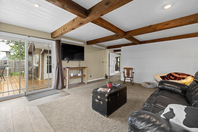 living room with baseboards and beamed ceiling