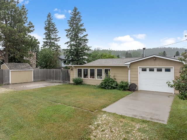 ranch-style home featuring a garage, driveway, a front lawn, and fence