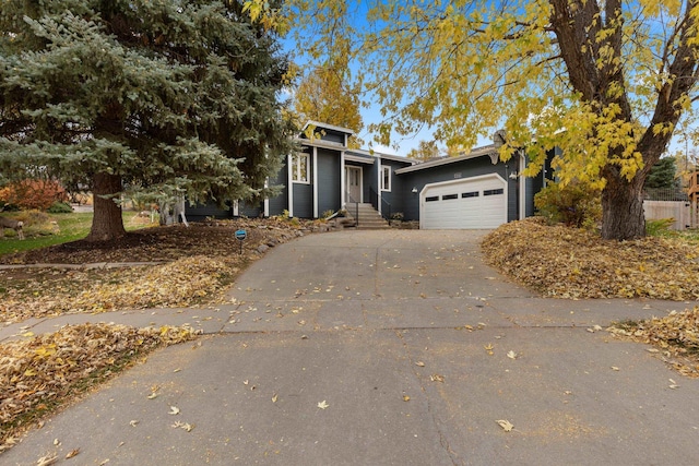 view of front facade featuring an attached garage and aphalt driveway