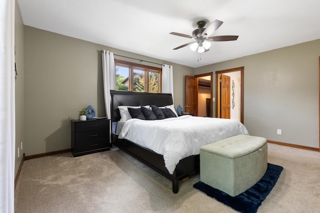 bedroom with light carpet, ceiling fan, and baseboards