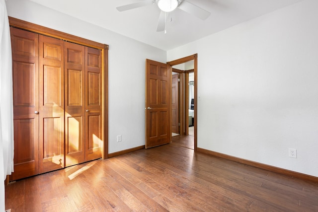 unfurnished bedroom featuring a ceiling fan, baseboards, and wood finished floors