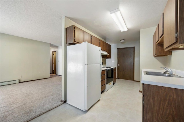 kitchen with electric range, freestanding refrigerator, light countertops, under cabinet range hood, and a sink