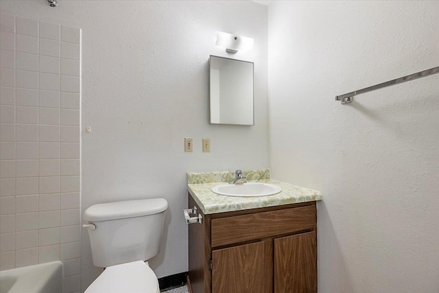 bathroom featuring toilet and vanity