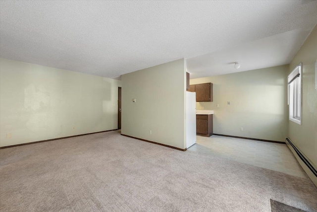 unfurnished living room with a baseboard radiator, baseboards, a textured ceiling, and light colored carpet