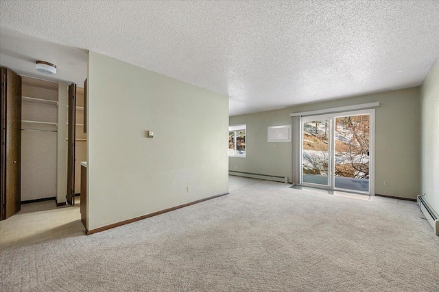 interior space featuring carpet floors, a baseboard radiator, baseboards, and a textured ceiling