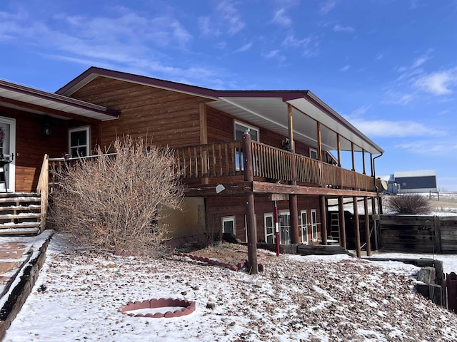 snow covered property featuring a balcony