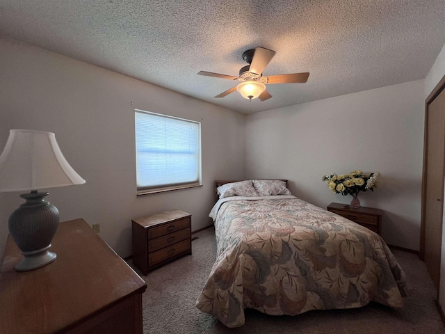 bedroom with light carpet, ceiling fan, and a textured ceiling