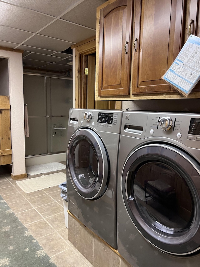 laundry room featuring independent washer and dryer and light tile patterned floors