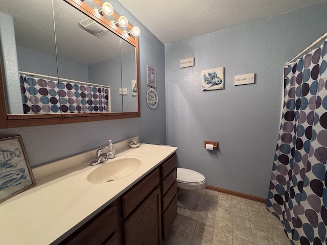 full bathroom with a textured wall, toilet, vanity, and baseboards