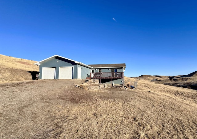 view of front of home featuring a garage and a deck