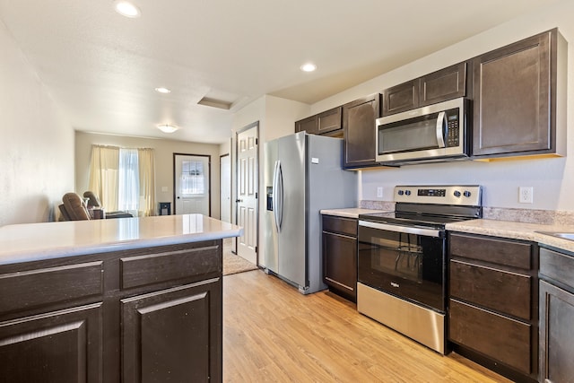 kitchen with appliances with stainless steel finishes, light countertops, and dark brown cabinetry