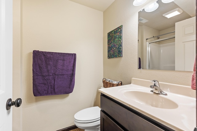 bathroom with toilet, visible vents, a shower, and vanity