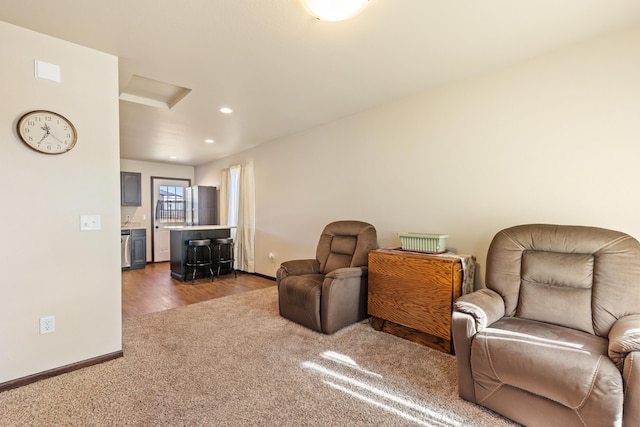 living area with dark carpet, recessed lighting, attic access, and baseboards