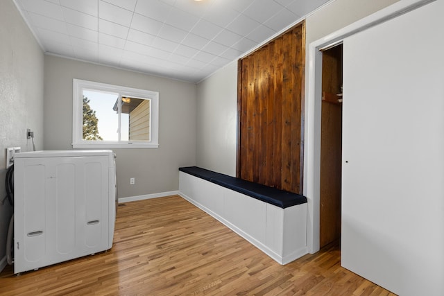 washroom featuring laundry area, ornamental molding, and light wood-style floors