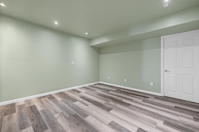 basement with recessed lighting, light wood-type flooring, and baseboards