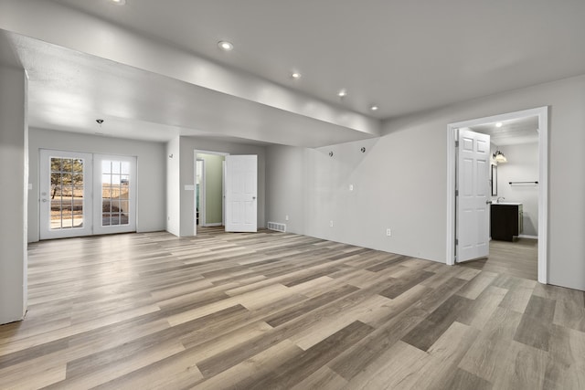 unfurnished living room featuring light wood-style flooring and recessed lighting