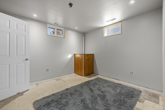 basement with plenty of natural light, visible vents, and recessed lighting